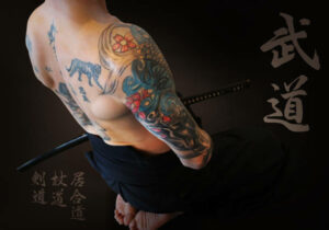 Tattooed naked samurai's revenge. Brave samurai and his katana sword in the japan dojo.